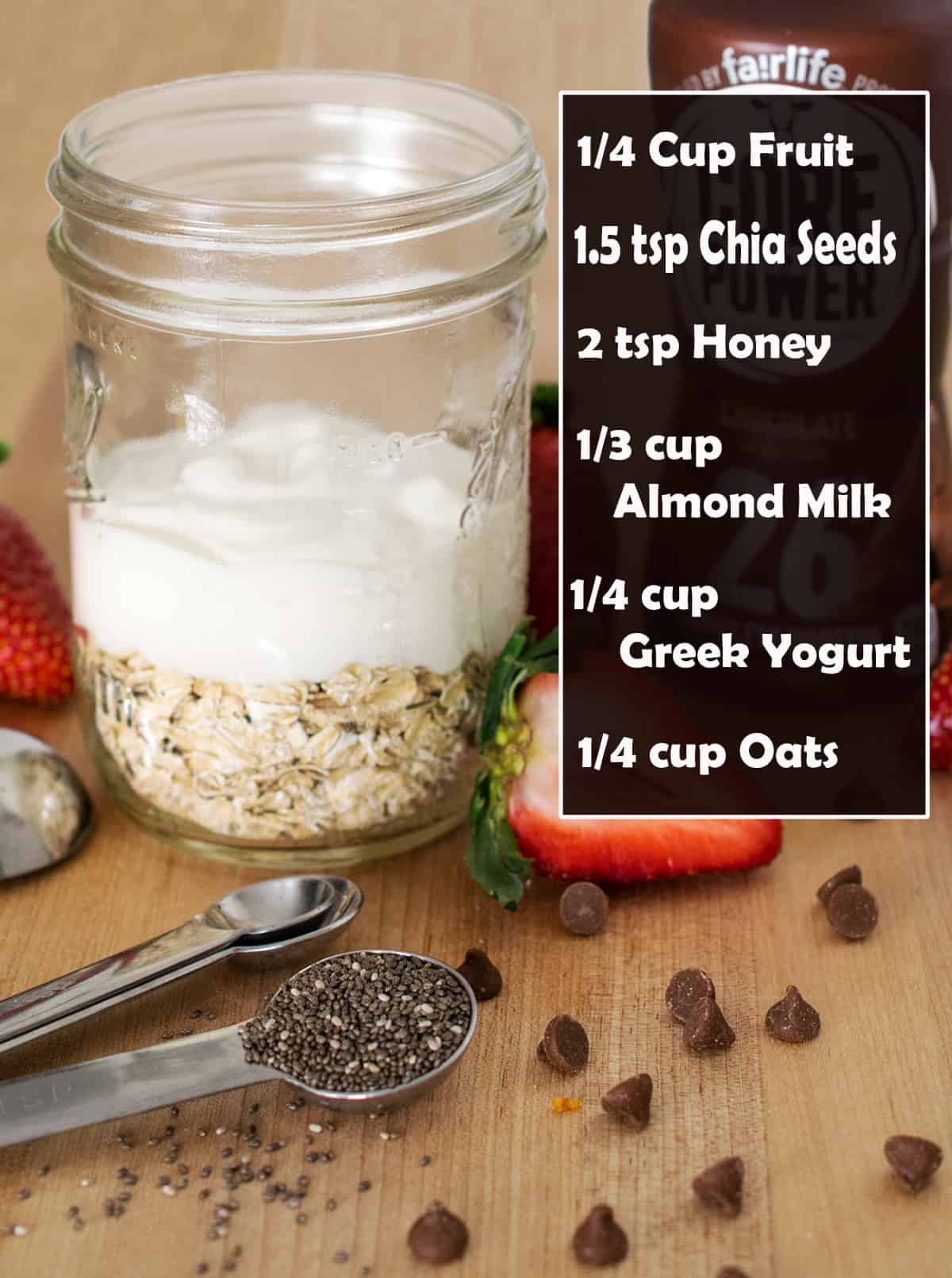 A mason jar filled with oats, greek yogurt, almond milk, chia seeds, and honey on wooden cutting board.  text label of recipe.