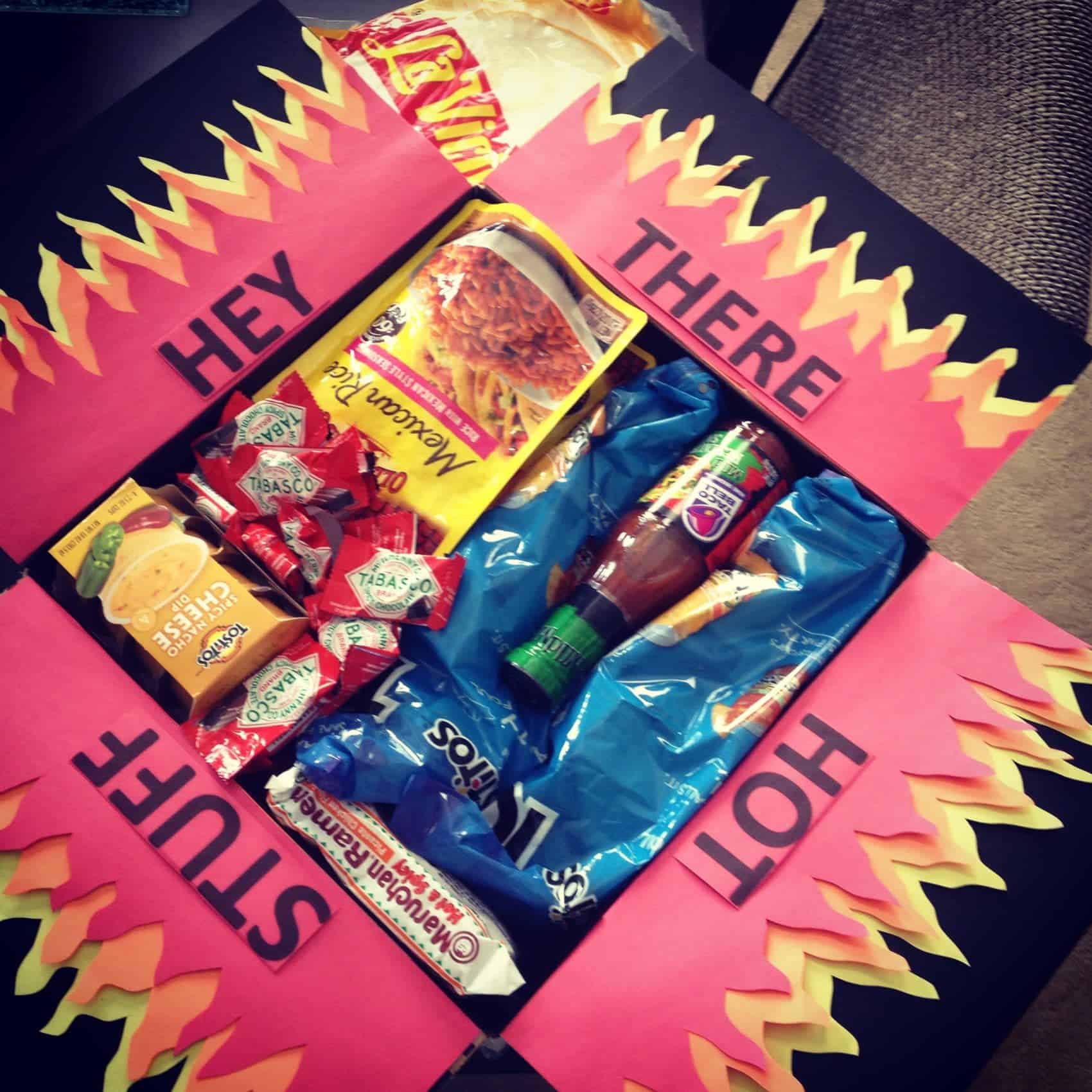 Hey there hot stuff care package with flame paper attached to fold out top filled with spicy foods. 