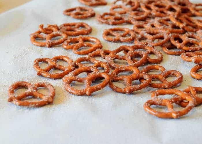 Sugared pretzels spread out on a cookie sheet and wax paper to show texture