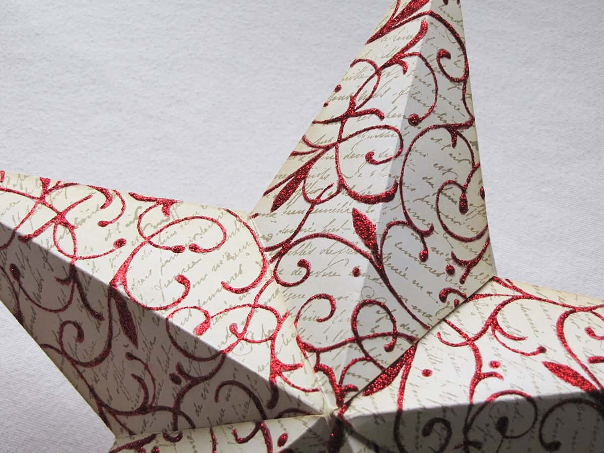 Closeup of a stamped and decorated 3d paper star.