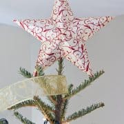 Paper 3-D star atop tree. Star is stamped red and white with glitter.