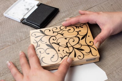 Wooden decorative paper stamp with modern floral design.