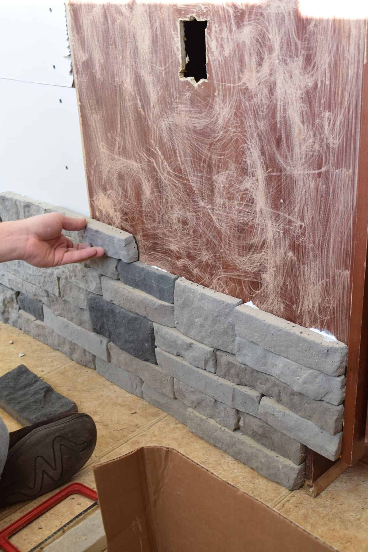 Giving a kitchen island makeover using airstone to create an artificial stone look.