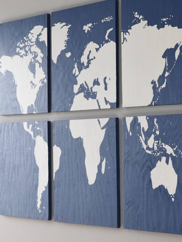 DIY map art with post title and artwork hanging in the bedroom.