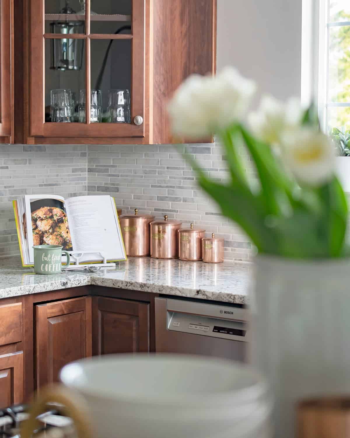 Set of antique canisters on kitchen countertop after being restored to original luster.