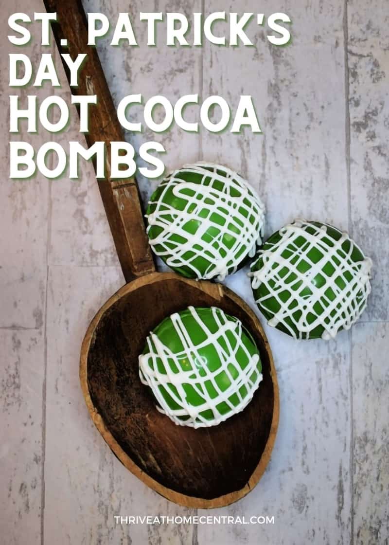 St Patricks Day Green hot cocoa bombs on a spoon with title.