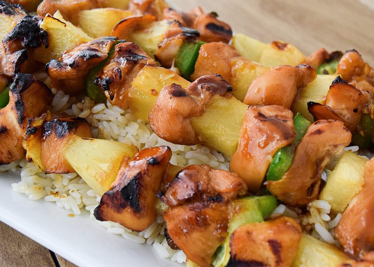 Skewered honey teriyaki chicken kabobs with green pepper and pineapple chunks served over rice.