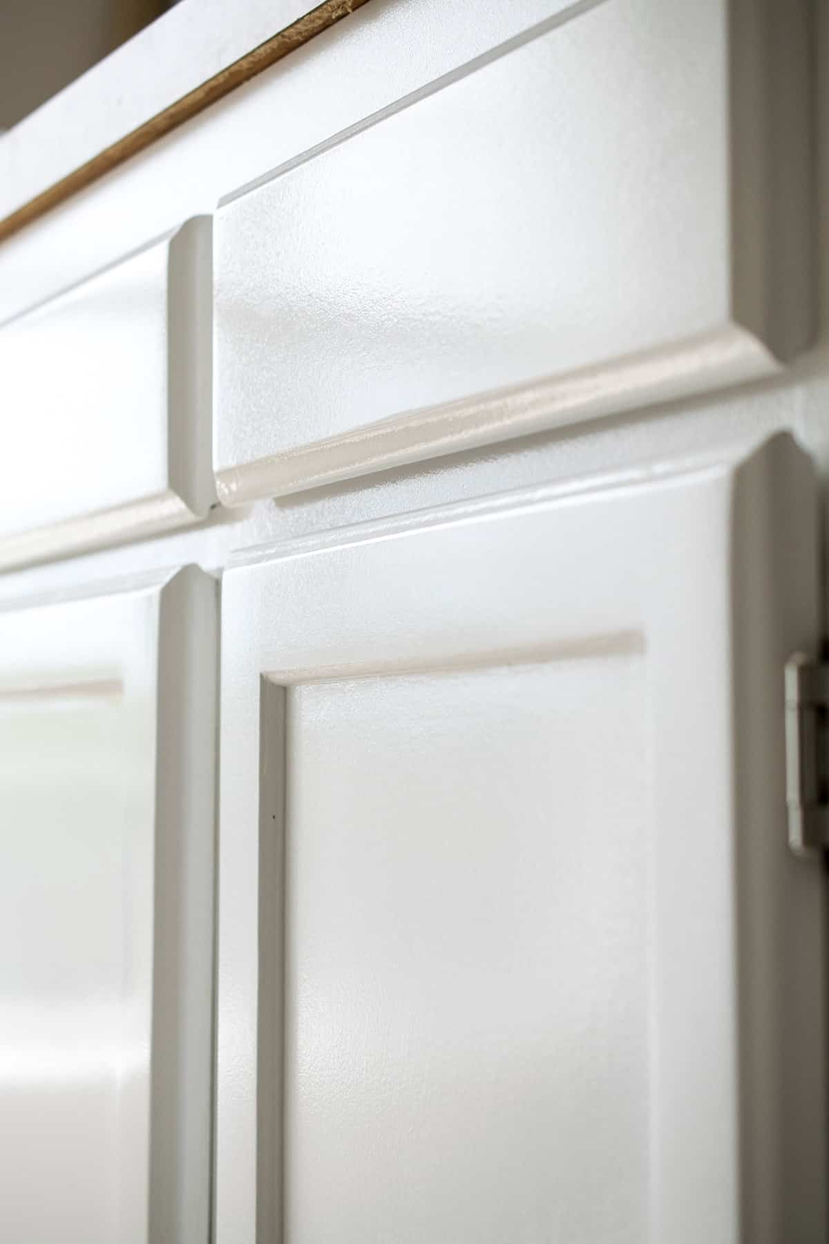 Cabinet door fronts painted white. 