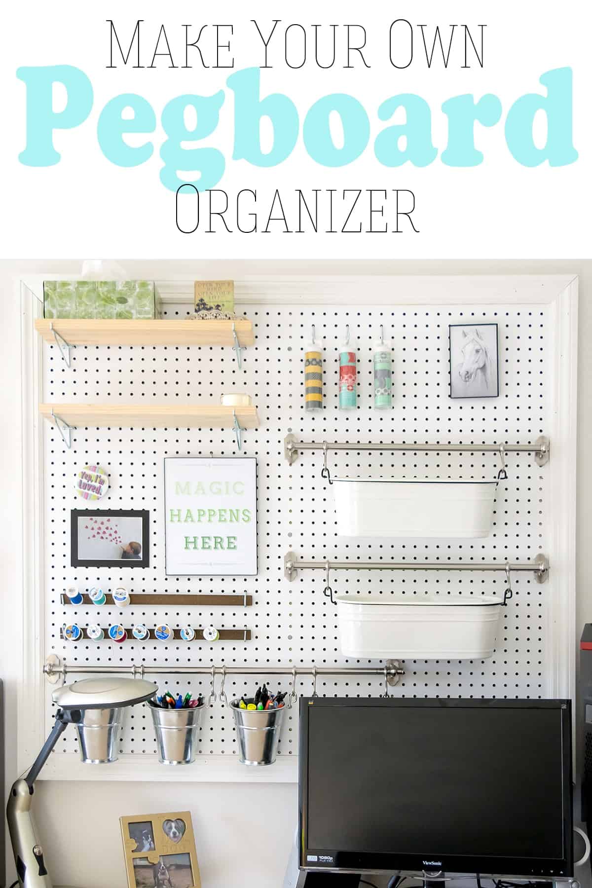Large white pegboard on wall for craft supply storage hanging over  computer desk area.