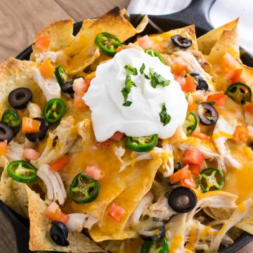 Shredded Chicken Nachos - Shredded Chicken and Cheese, Olives, Pickled Jalapenos and alll the trimmings for a supreme appetizer or game day treat.