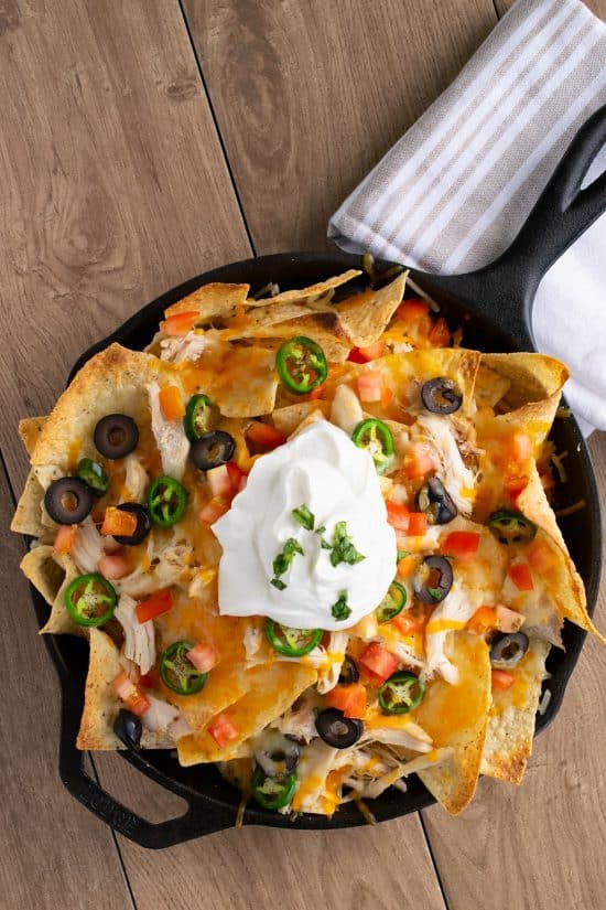 Shredded Chicken Nachos - Shredded Chicken and Cheese, Olives, Pickled Jalapenos and alll the trimmings for a supreme appetizer or game day treat.