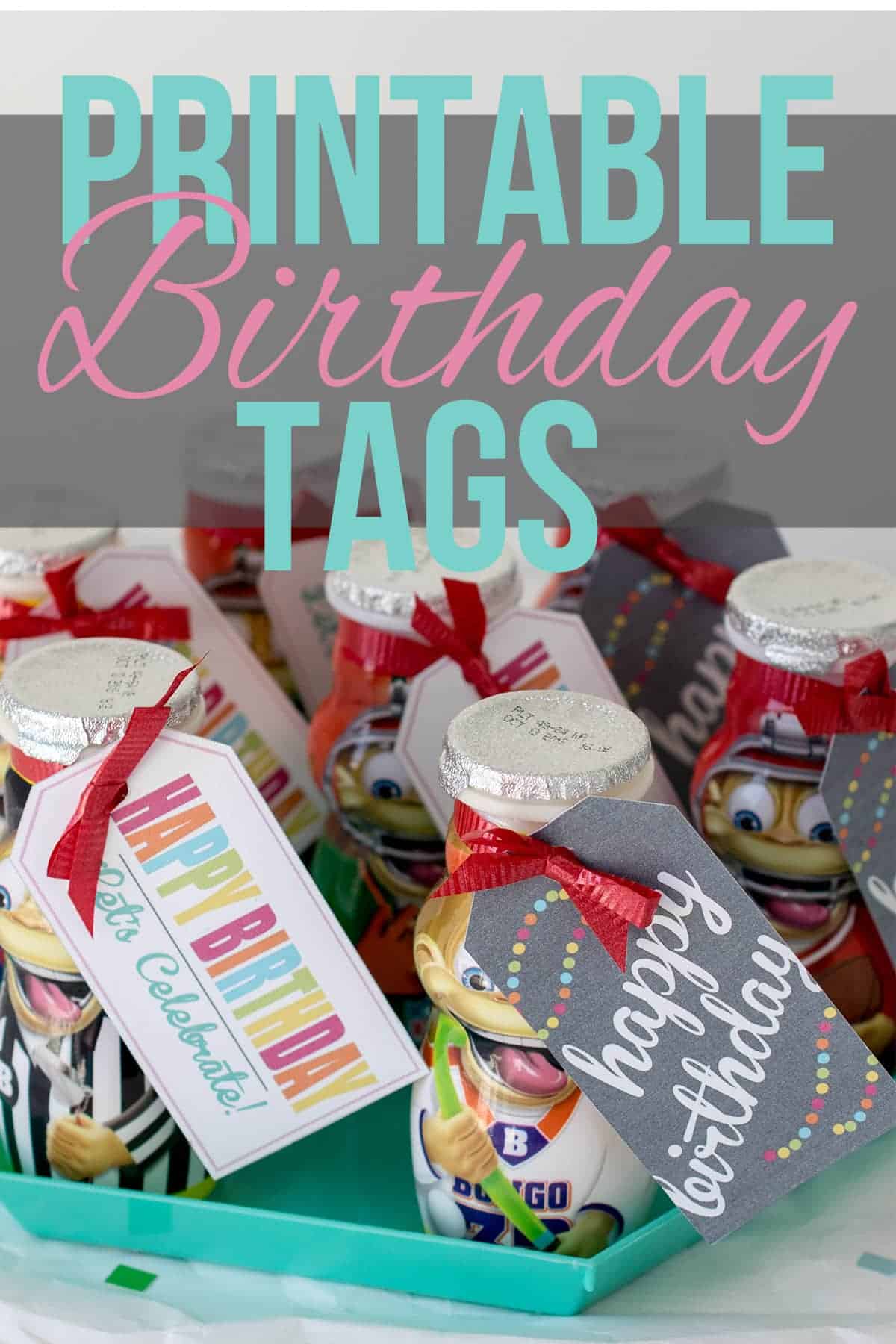 Classroom birthday treats-yogurt smoothie treats on turquoise hexagonal tray, wrapped in red bows with printable labels on white surface with colored confetti. 