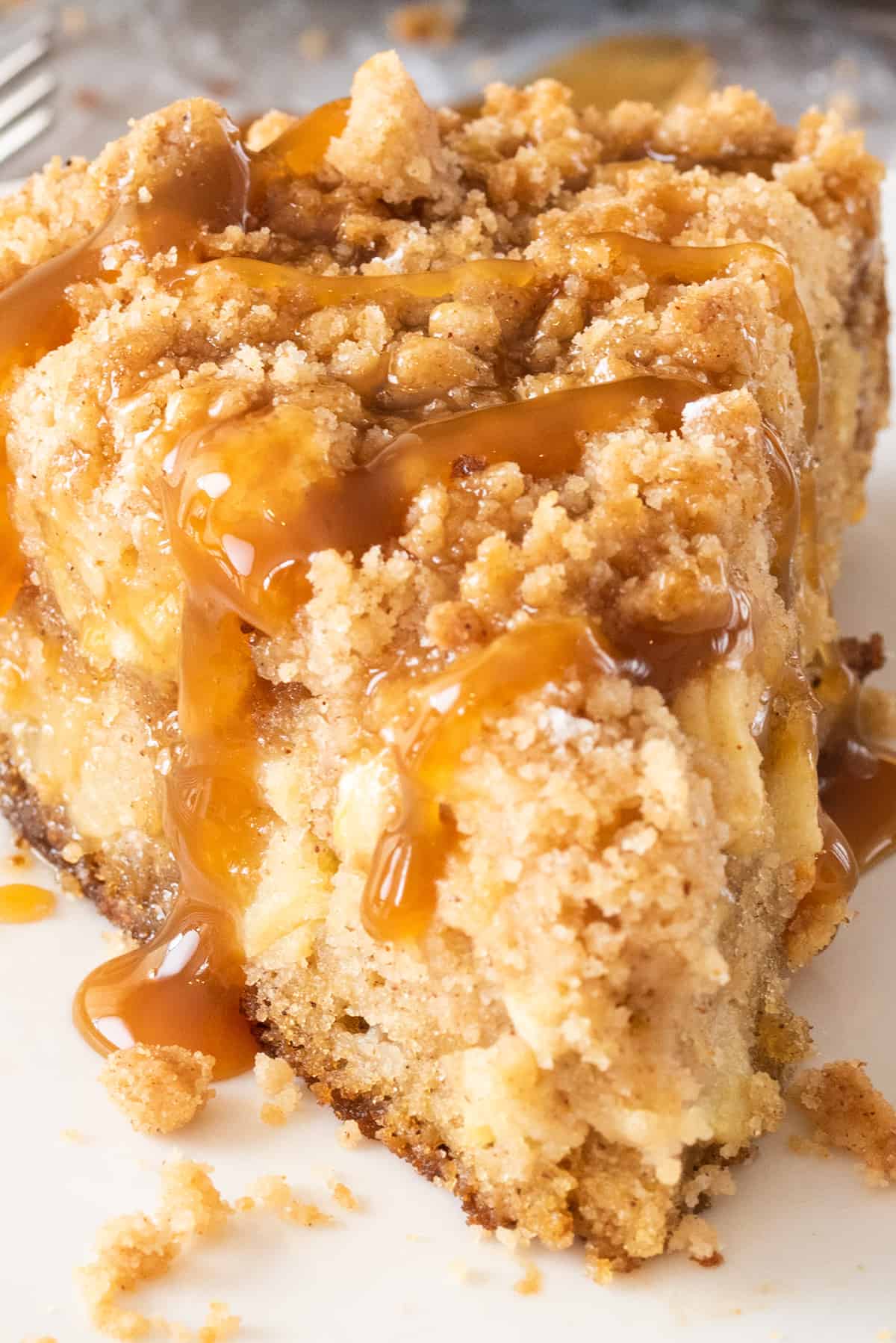 Closeup of Apple Crumb Cake slice with caramel drizzle.