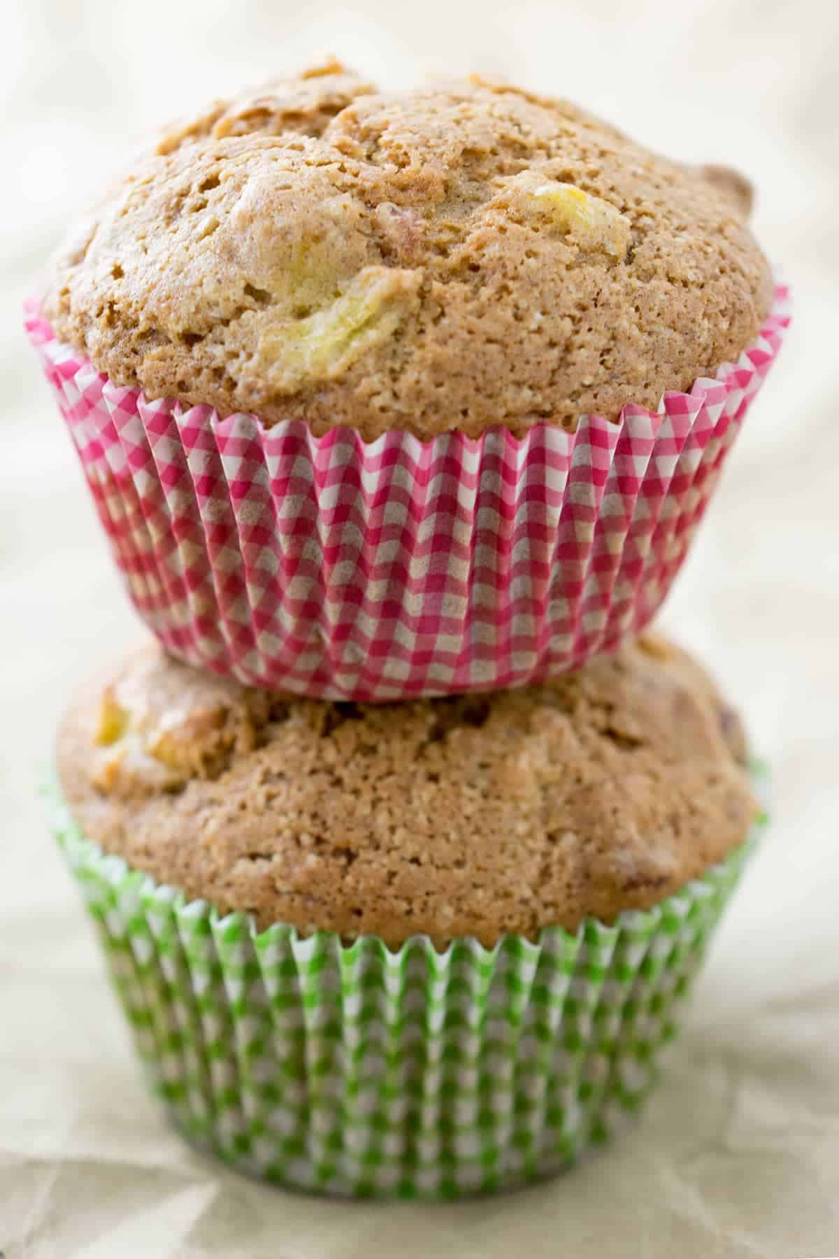 Two squash muffins stacked on top of one another in colorful wrappers.