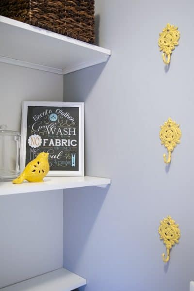 Open shelves in a laundry room for organization and storage of supplies.