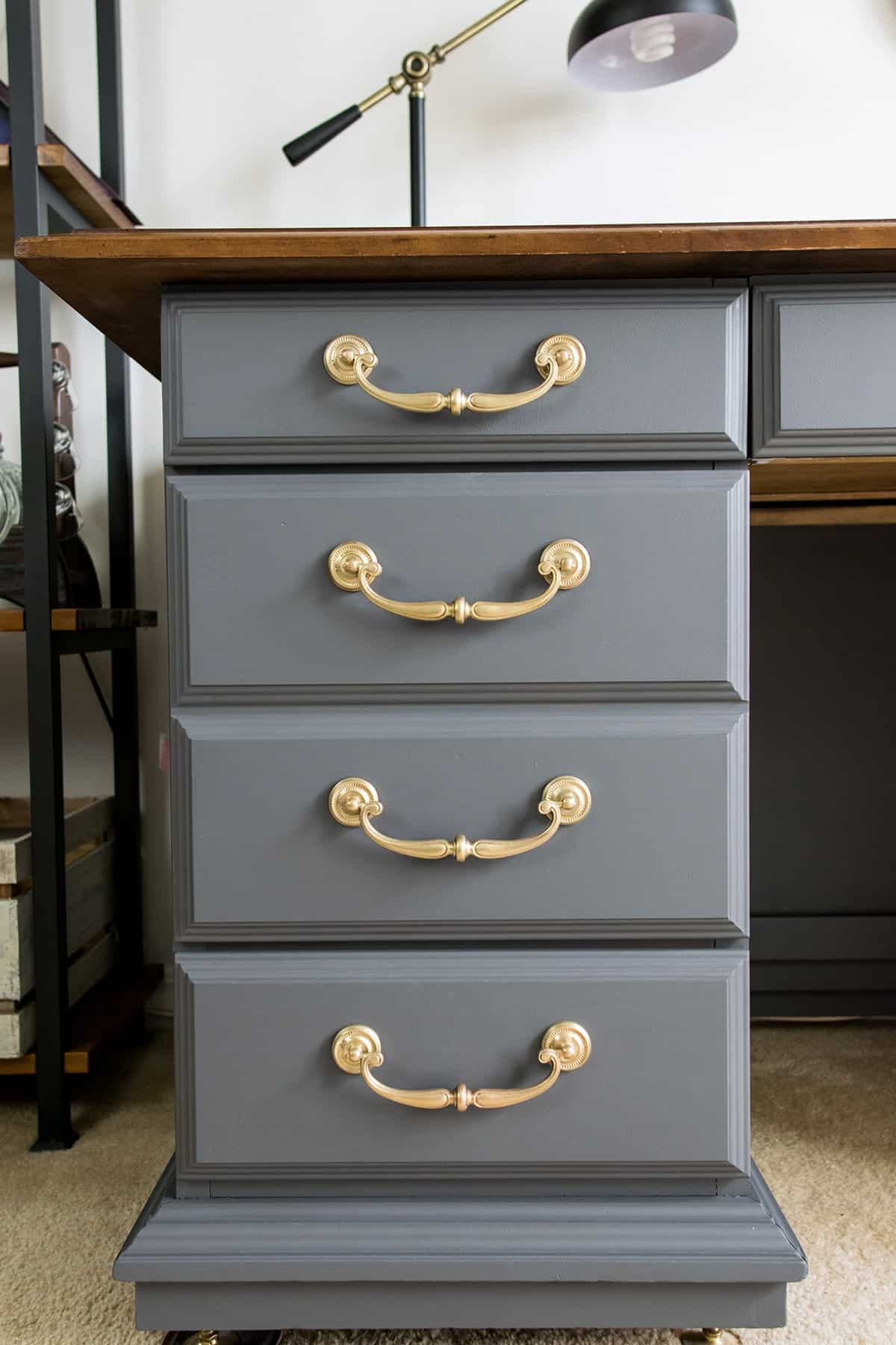 Polished brass hardware on vintage gray desk makeover in home office. 