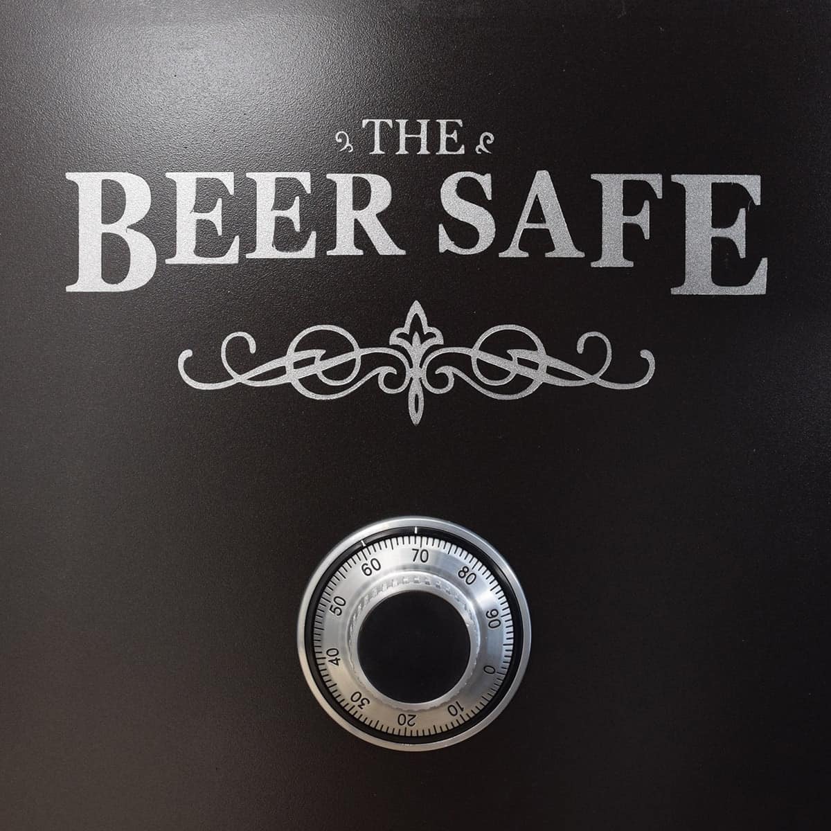 Close up of beer safe stencil detail on black fridge with authentic safe dial. 