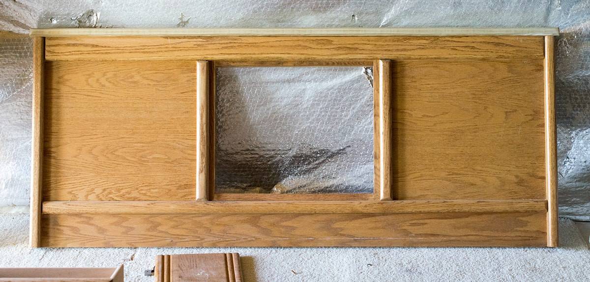 Footboard of wooden bed removed to be refinished.