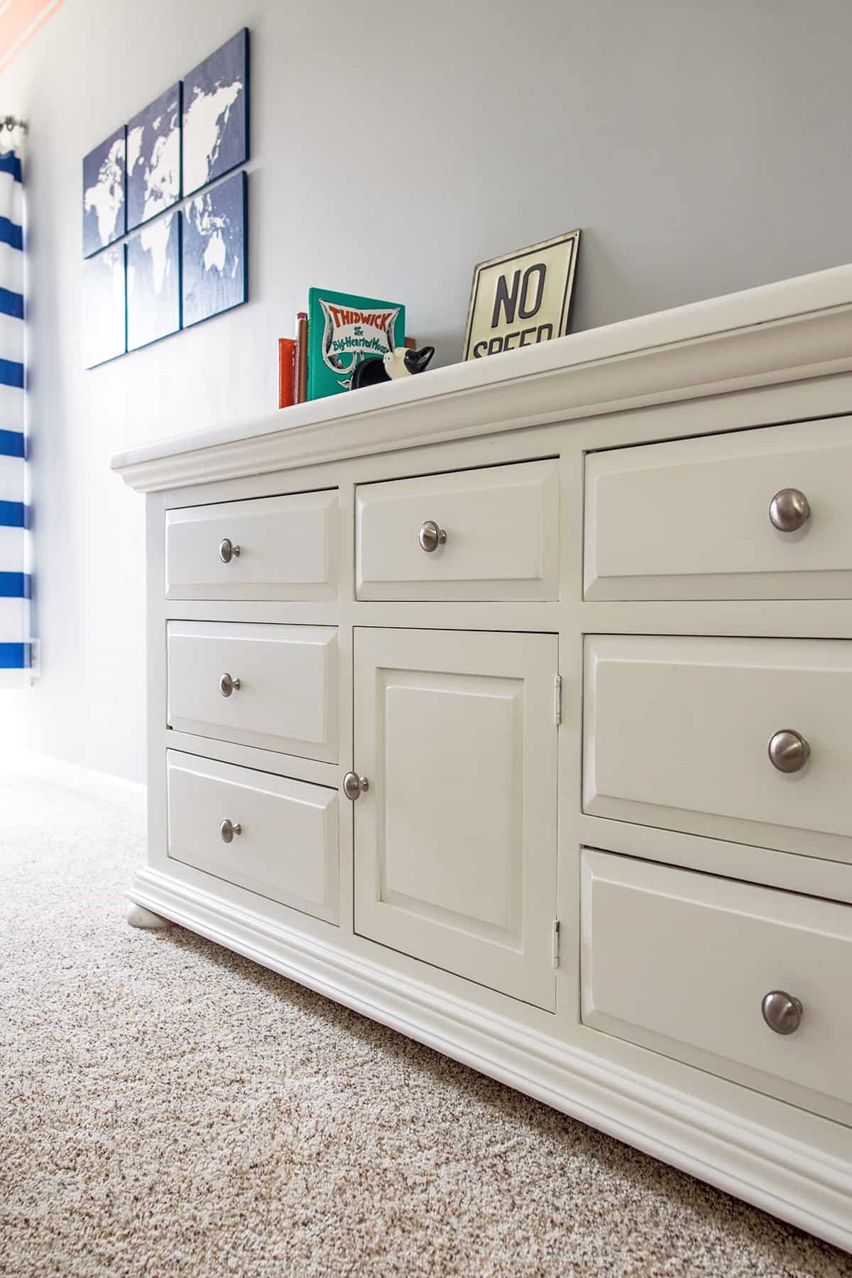 DIY pine dresser makeover with fresh white paint and satin nickel drawers pulls in gray little boy's room. 