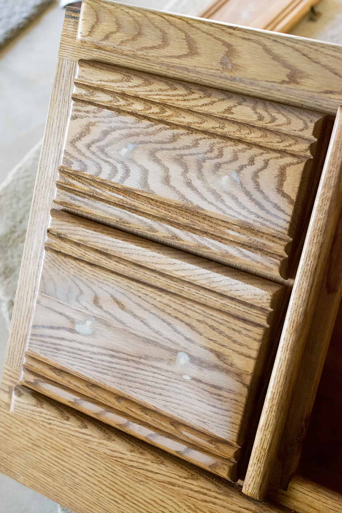 Drawers from side of bed with holes filled with wood filler and sanded.