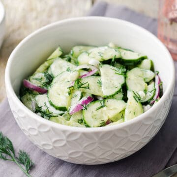 Cucumber Onion Salad with Dill Yogurt Dressing in a bowl.