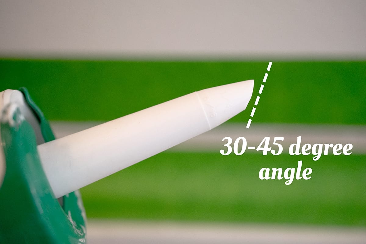 How to cut a tube of caulk at a proper angle for maximum distribution.