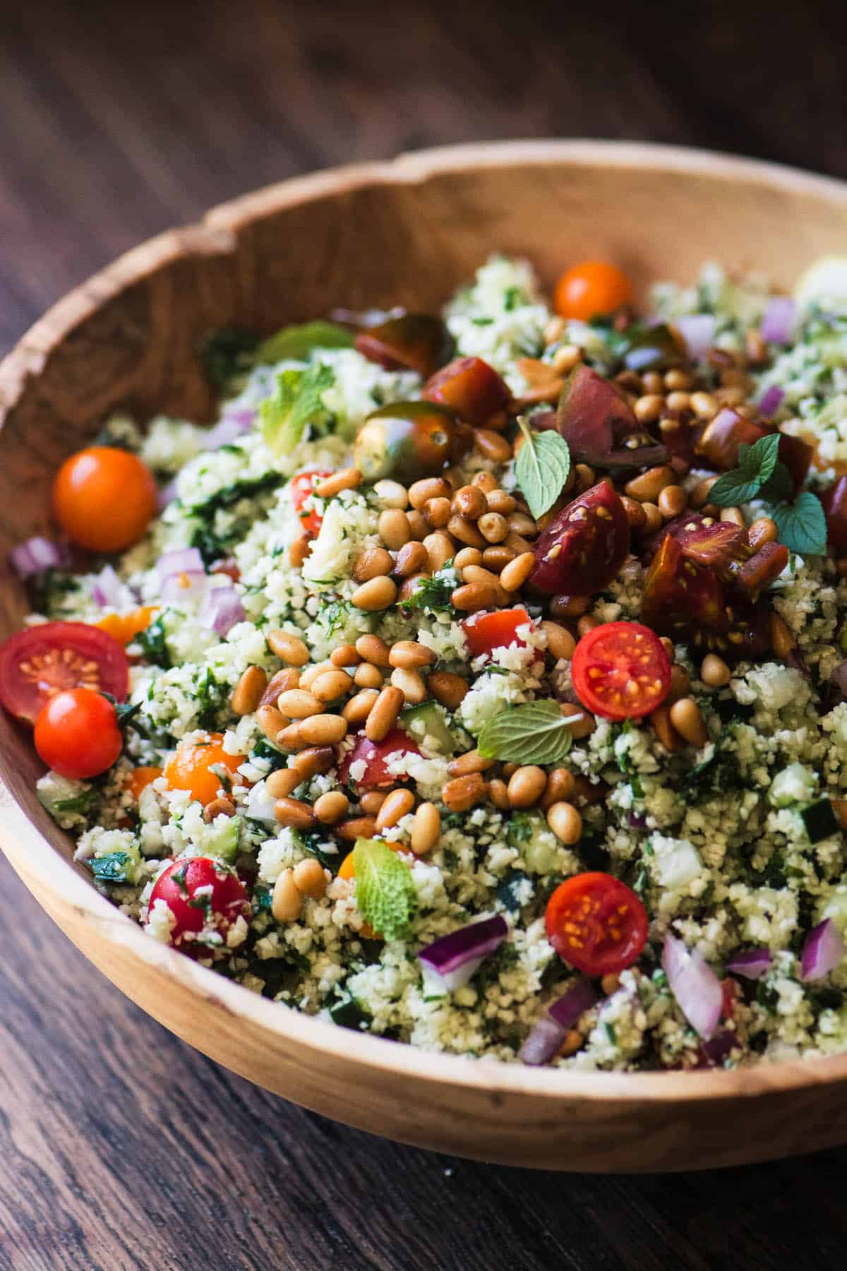 Side view of cauliflower tabbouleh in a bowl.