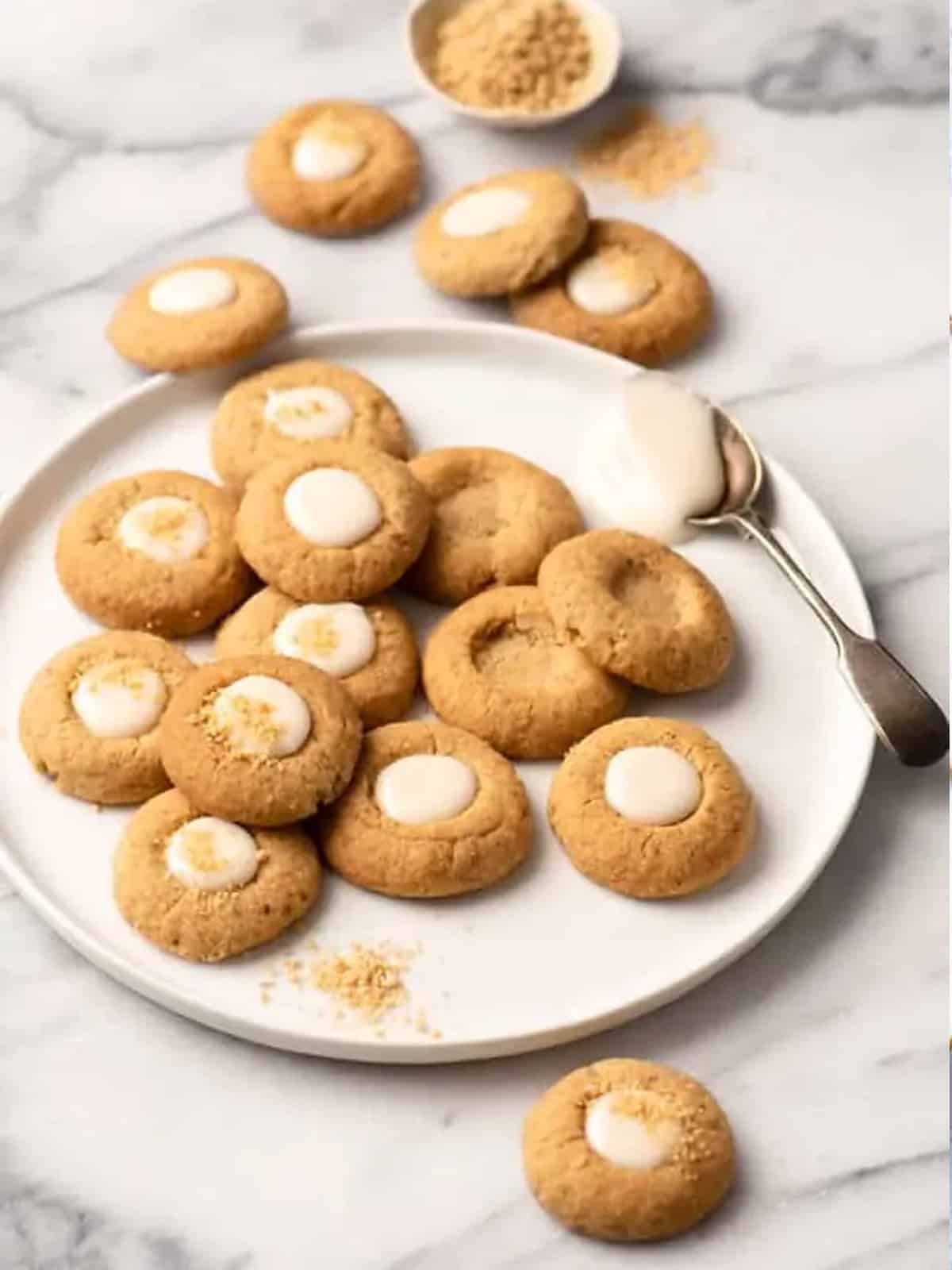 Maple thumbprint cookies on a plate with maple filling.