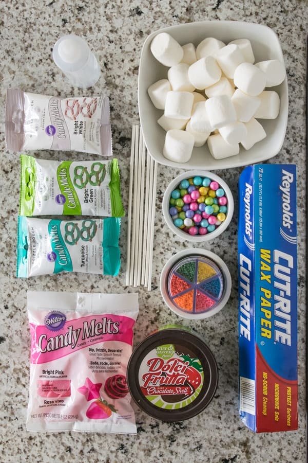 Ingredients and candies used to make a cake pop decorating station.