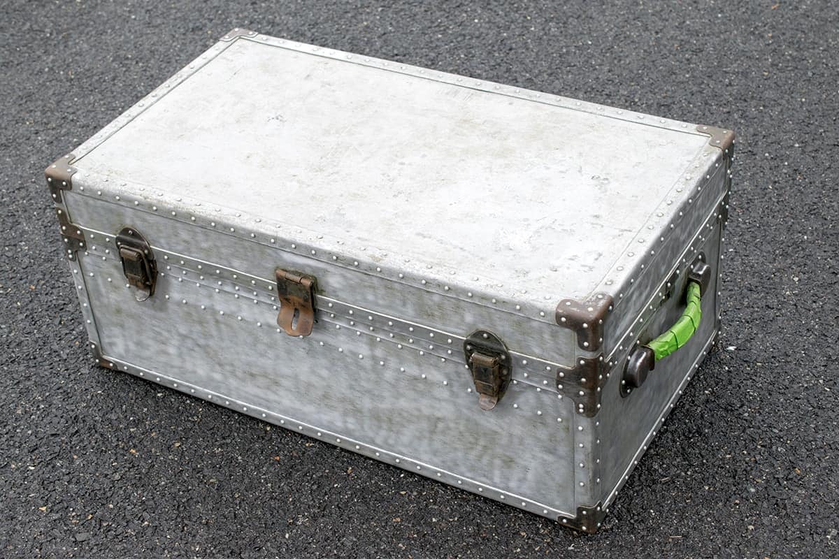 Steamer trunk or military footlocker after stripping paint from the metal.