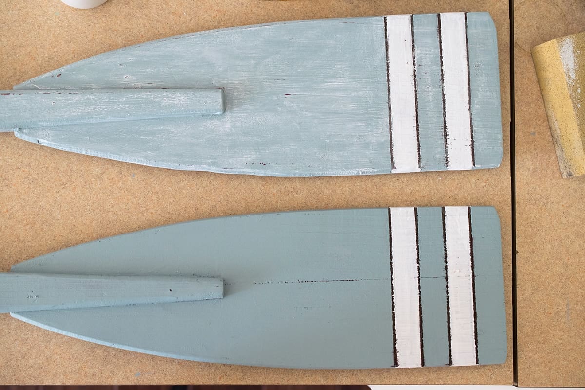 Whitewashed boating oars in soft blue before and after painting.