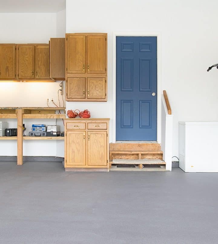 Garage with gray painted floor that is clean and organized.