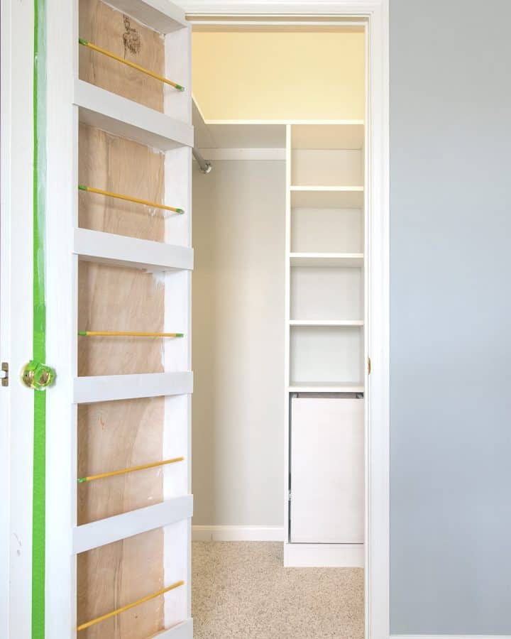White built-in custom closet shelves and door organizer with closet Ikea hack Billy bookcase.
