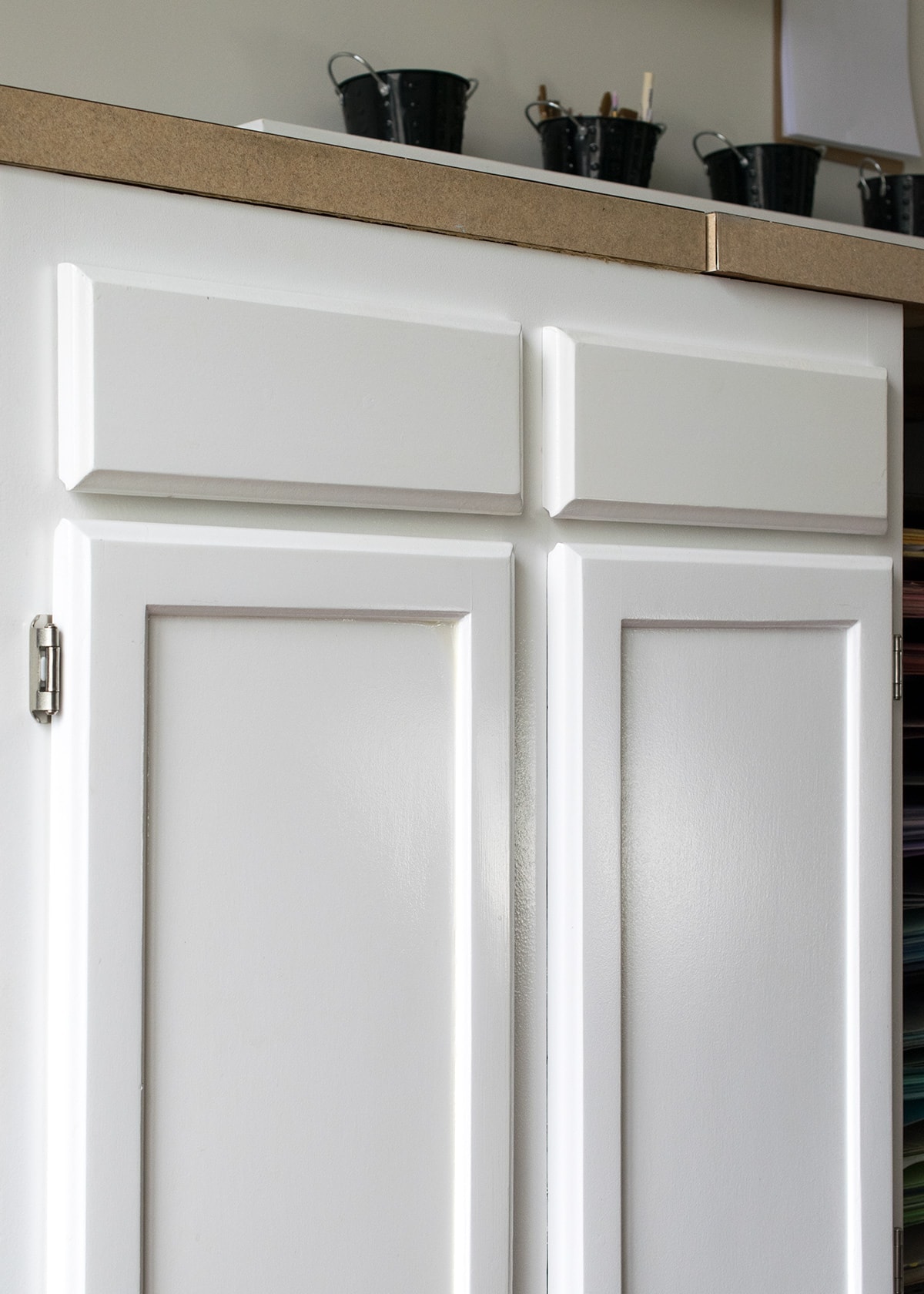 Refinished cabinets in craft room painted with a fresh coat of white paint 