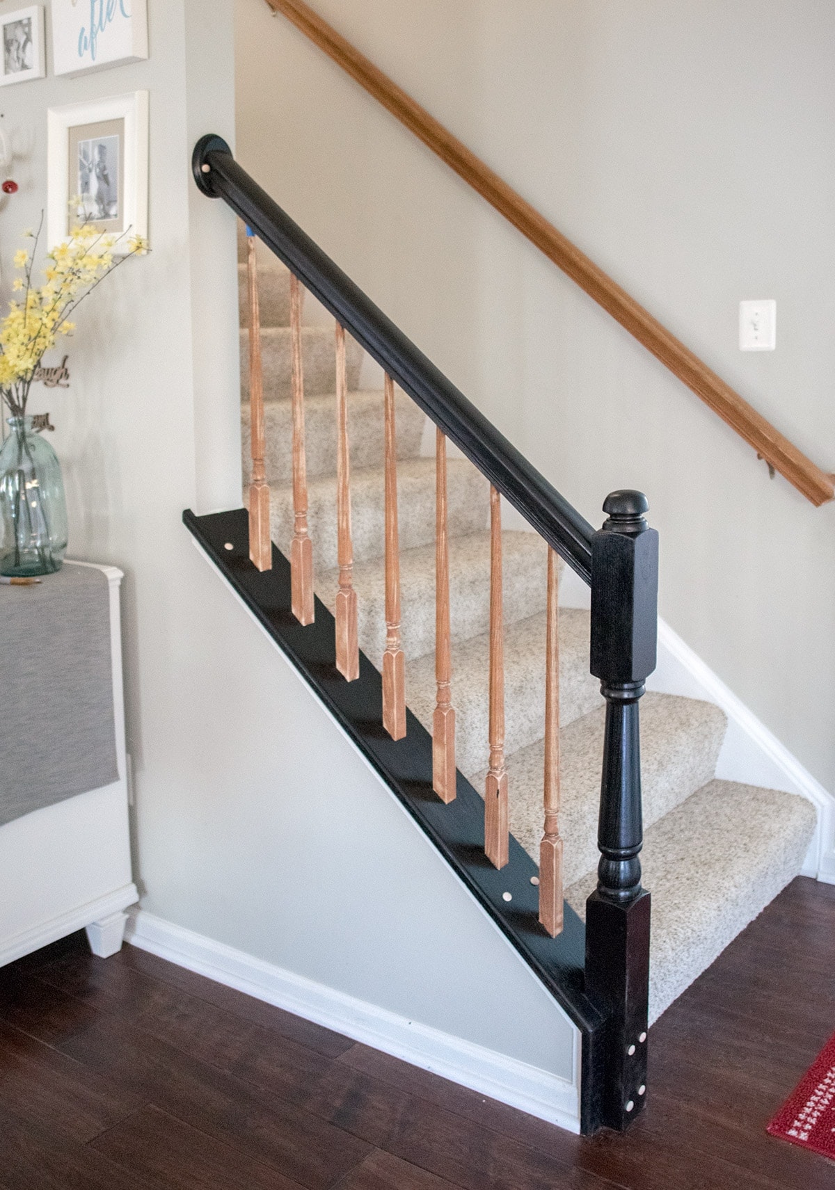 In progress of painting oak wood stairwell with a new, black finish 