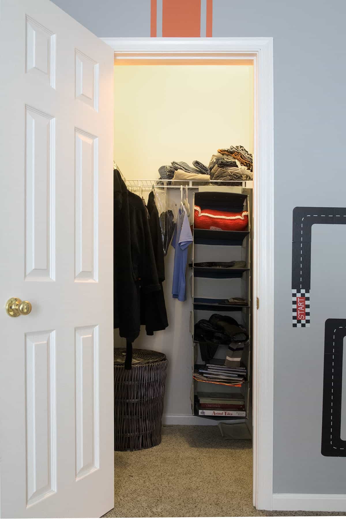 Basic builder grade closet in boys room before creating a custom closet.