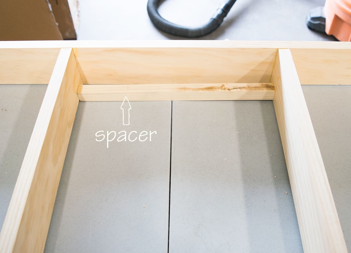 Spacer placed between shelves to quickly space bookshelf frame.