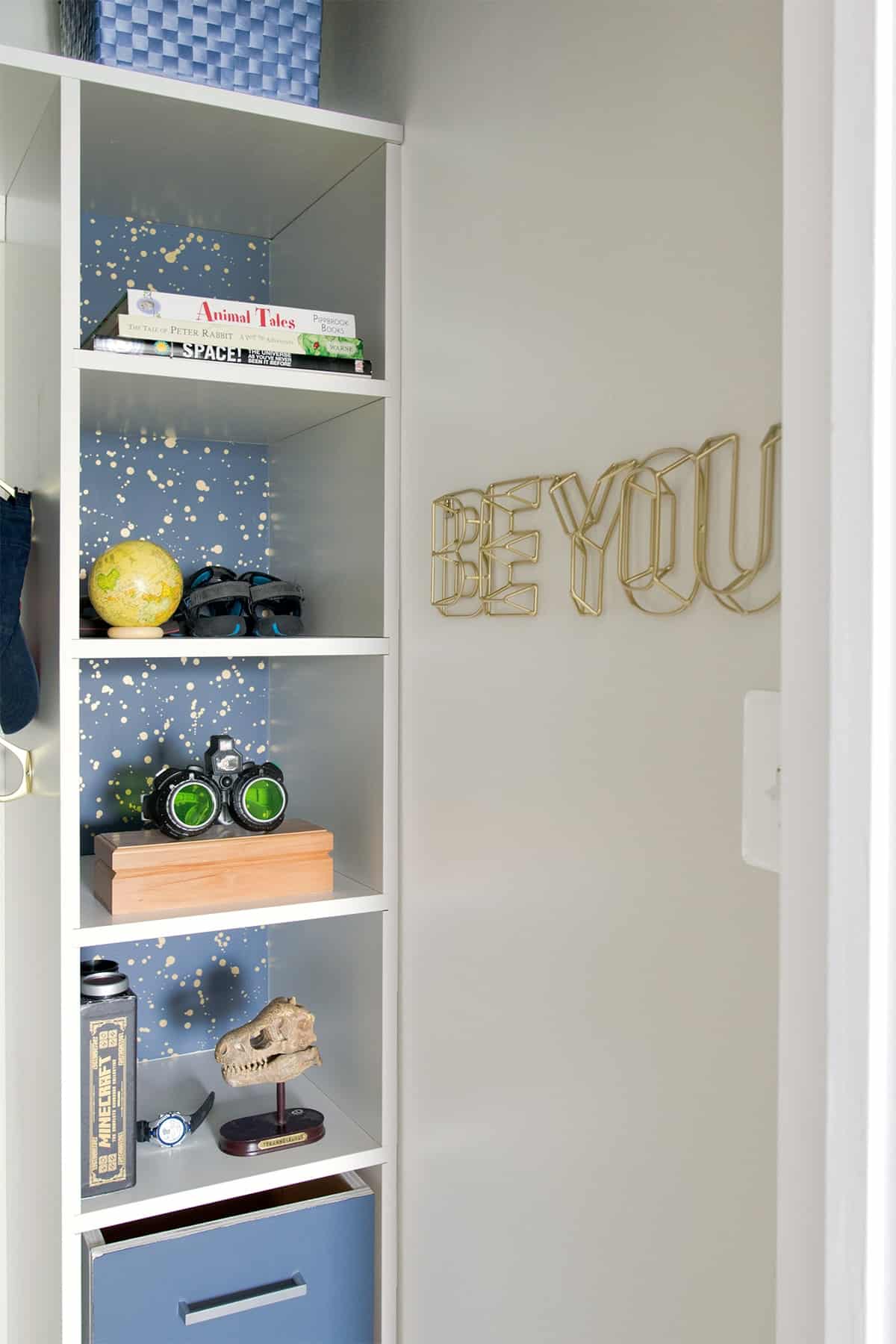 Kids closet organization idea with shelves and laundry hamper.