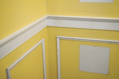 How to install wainscotting with trim nailed into wall.
