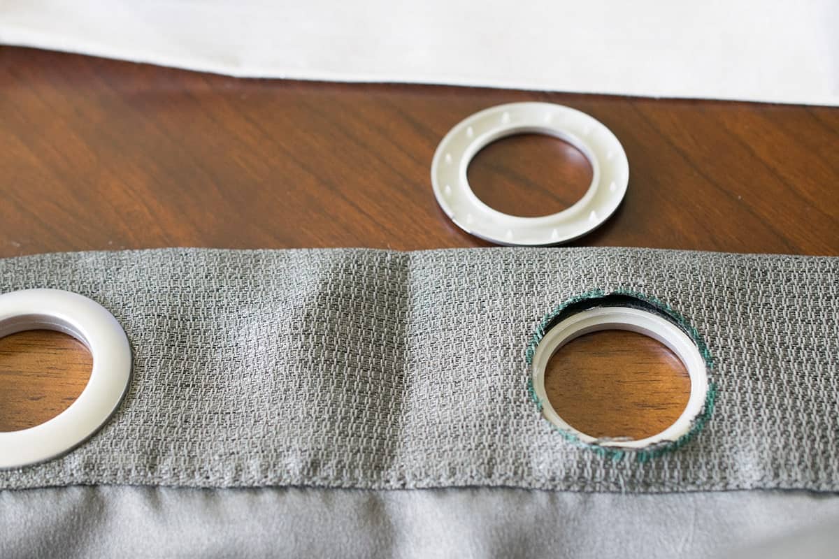 An eyelet half placed inside a circle ready for the other half to be placed on top.