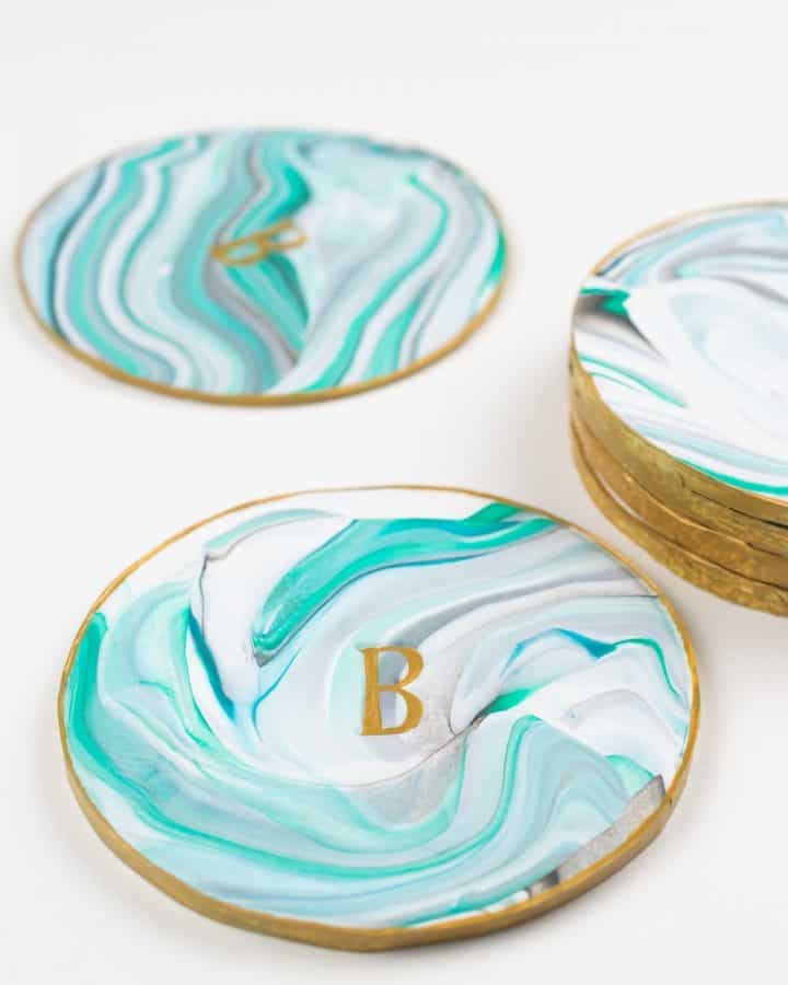 Monogrammed diy polymer clay coasters made out of clay and set on a white background.