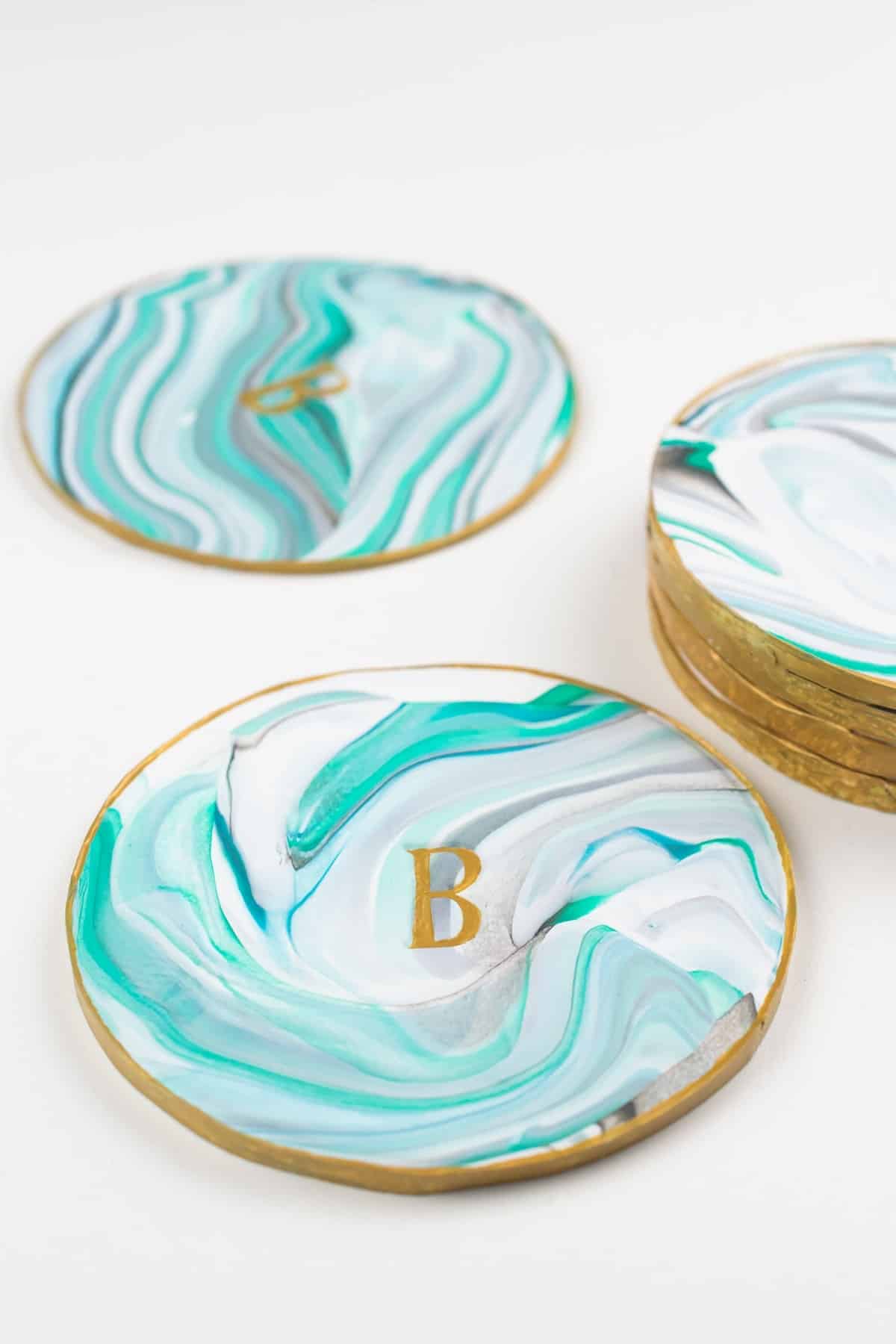 Monogrammed diy polymer clay coasters made out of clay and set on a white background.