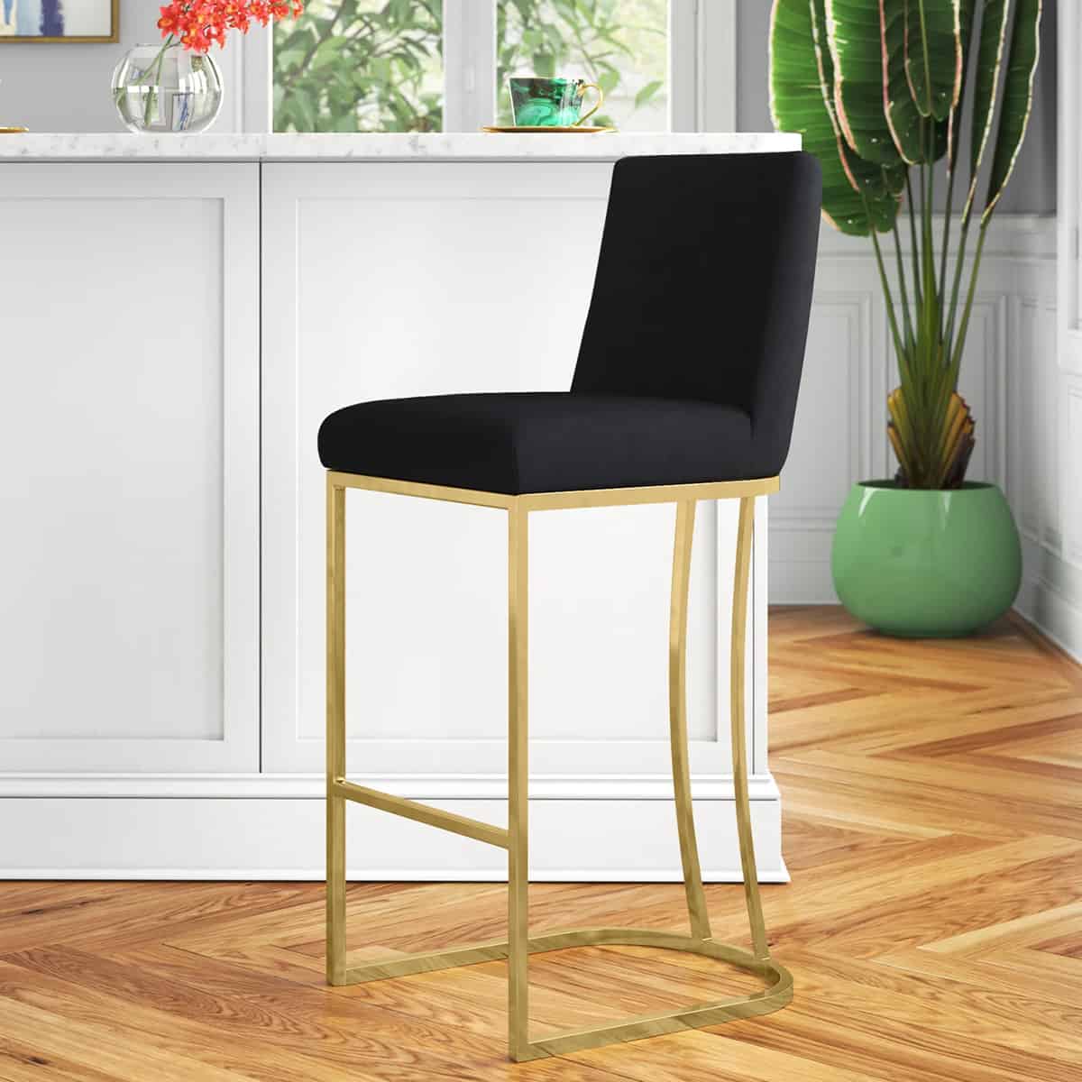 Black bar stool with a square back and gold trim.