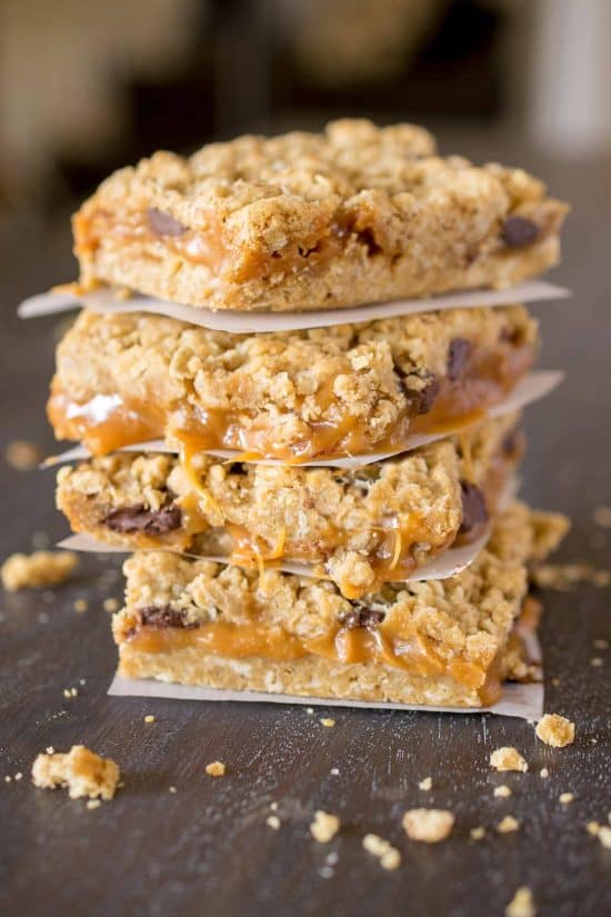 Caramel Chocolate Chip Cookie Bars stacked on top of each other.