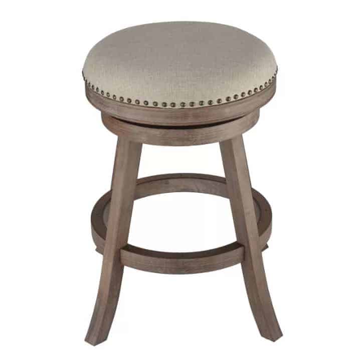 Counter stool with grey wood and beaded beige seat.
