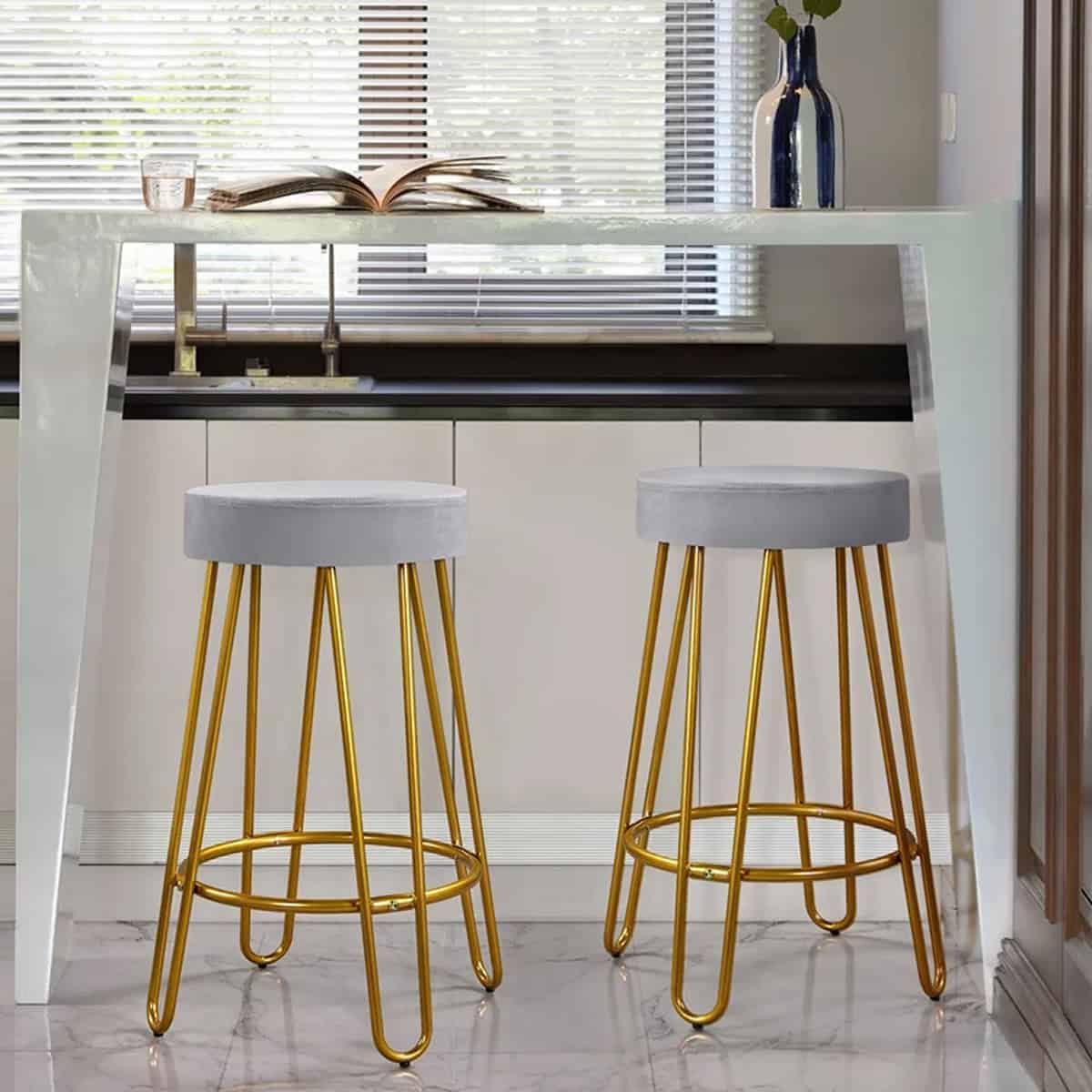 gold backless stools under a counter.