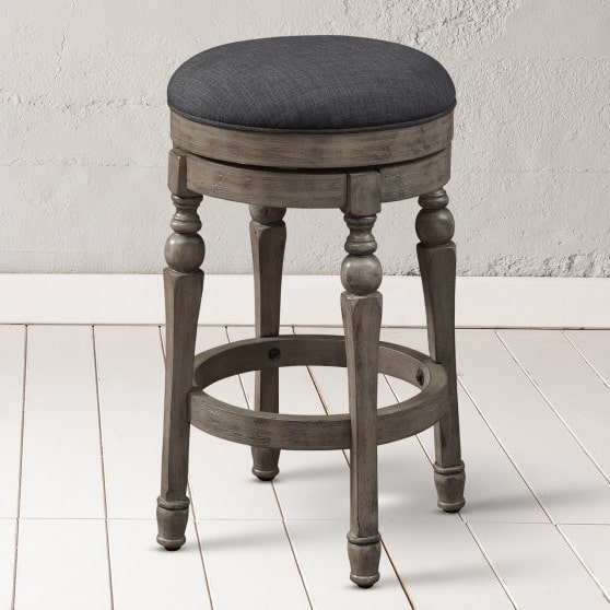 Dark grey counter seat with wood legs in a round shape.