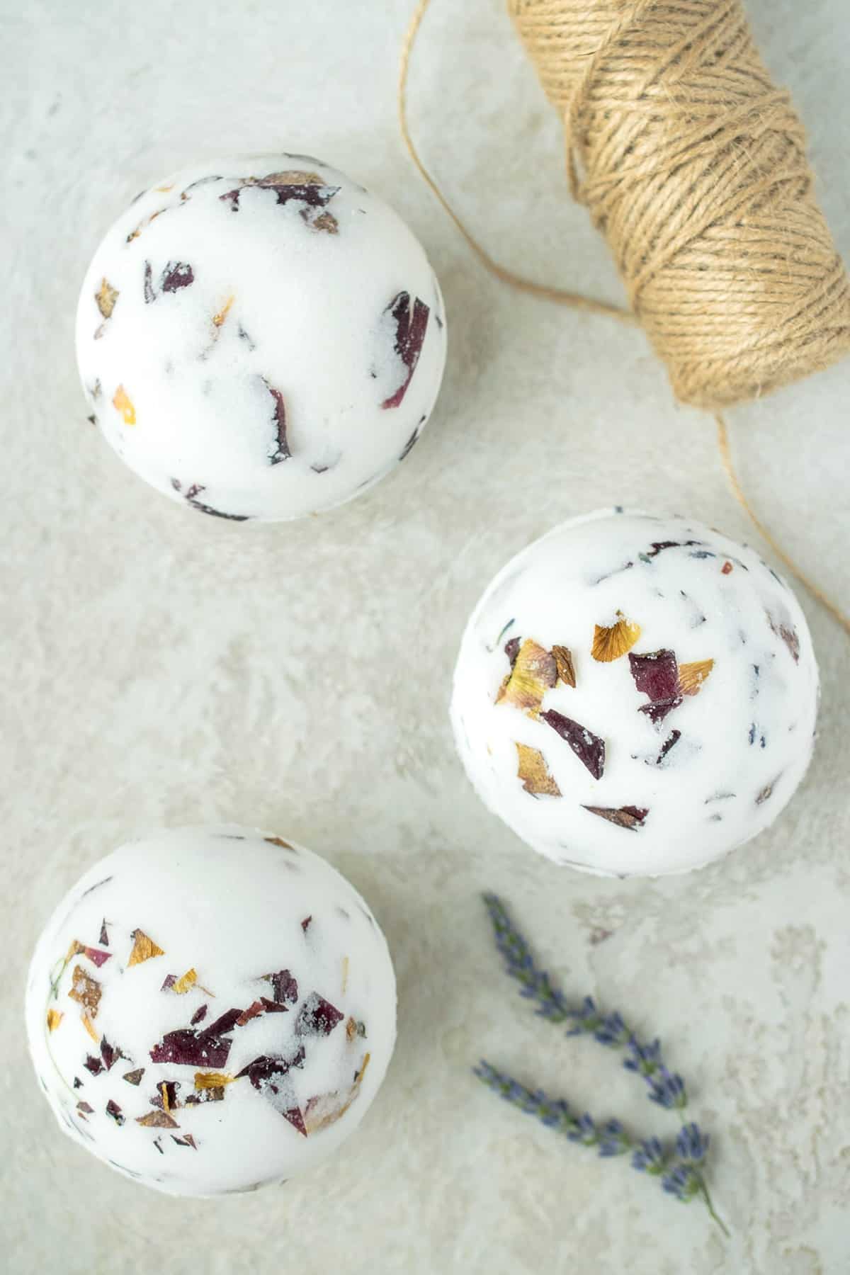 White lavender rose speckled bath bombs with twine in the background