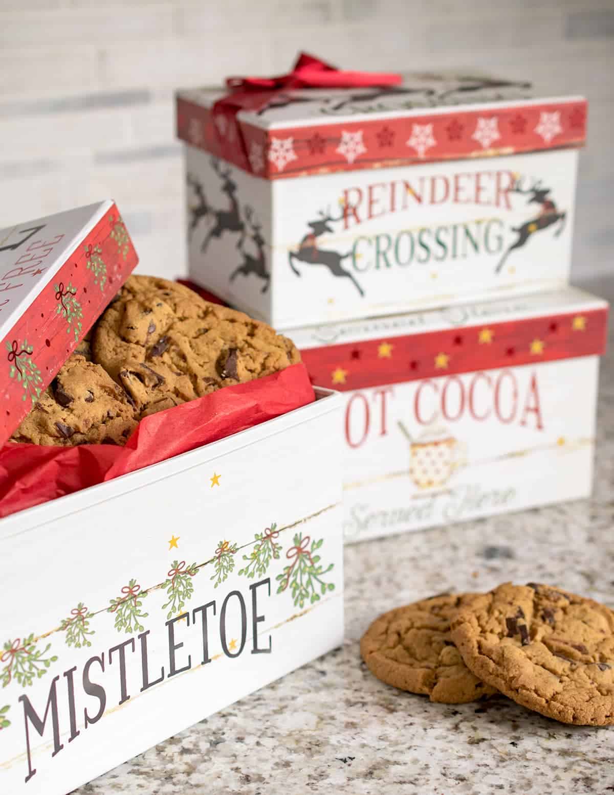 Christmas themed nesting boxes filled with chocolate chip cookies.