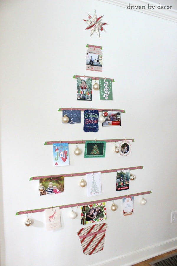 Christmas card display on a wall in the shape of a Christmas tree.